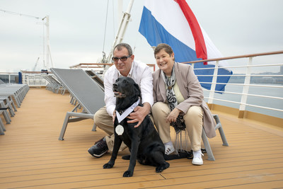 Joska poses with her people, Cornelius and Cornelia Marinussen, aboard Rotterdam on Oct. 26. Joska, a 10-yr-old service dog, was recognized for sailing 700 days aboard Holland America line ships, earning a Platinum Medallion and 5-star Mariner status.