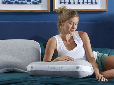 Featuring a crescent shape, the Flow Cuddle Curve pillow includes a soft T-shirt-like grey cover with metallic-silver-colored piping and white mesh sides that provide continuous airflow to let the body naturally regulate its temperature and create an ideal sleep environment.