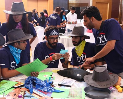 A group of Citibank employees are shown playing The Search for The Lost Dutchman's Gold Mine team building game in Mumbai, India. Over 1500 organizations in over 40 countries have engaged in the play and learning outcomes of Dutchman since 1993.
