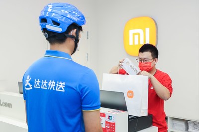 A Dada Now rider taking an order from a shop.