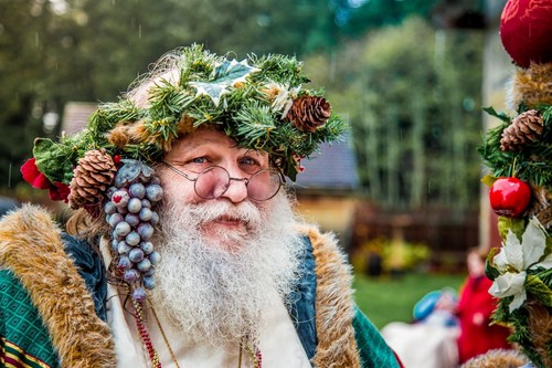 Father Christmas visits families at Christmas Regale at Fort Nisqually Living History Museum as part of the Simpler Times holiday travel itinerary for Tacoma and Pierce County.