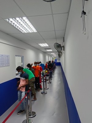 Migrant workers registering for a consultation at the Fullerton Health Medical Centre for Migrant Workers @ Gul Circle