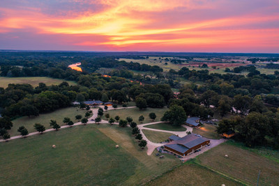 Beautiful sunsets provide a colorful backdrop to the property's manicured grounds, with the sun's red and orange hues reflected on the surface of the Brazos River. TexasLuxuryAuction.com.