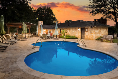 The outdoor living areas of the Creek House, the property's other residence, feature a custom pool with a large, stone-paver surround, jacuzzi tub and covered summer kitchen with countertop seating. The River House also has a jacuzzi tub. Property plans and features at TexasLuxuryAuction.com.