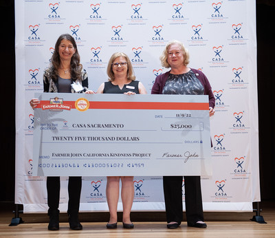 Adrienne Taylor, Farmer John representative, center, Diane Koellen, board president, left, and Carol Noreen, executive director, right, from CASA Sacramento with a check for $25,000 as part of Farmer John’s California Kindness Project – a grant program that launched earlier this year, designed to support committed California nonprofits that are making an impact in their local communities – on Wednesday, November 9, 2022 in Sacramento, Calif. (Anne Chadwick Williams/AP Images for Farmer John)