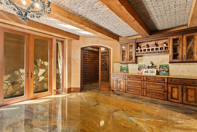The lower level hosts a climate-controlled wine room and a large tasting lounge. Exotic stone flooring, exposed beams and custom brick work lend a Tuscan feel, while natural light pours in through the French doors, which lead outside. More details at CaliforniaLuxuryAuction.com.