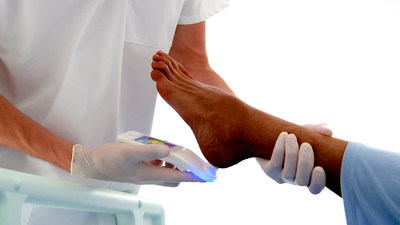 Healthcare Practitioner Scanning Patients Heel