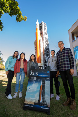 Student employees in the Industry Design Experience for Auburn Students, or IDEAS, program stand by a blow-up replica of the Space Launch System they are working on. Pictured are Regan Clare, junior<br />
in mechanical engineering; Ashley Eng, junior in mechanical engineering; Jessica Ruiz, junior in mechanical engineering; Matthew Gillis, senior in mechanical engineering and applied mathematics; and Bradley Conrad, senior in mechanical engineering.