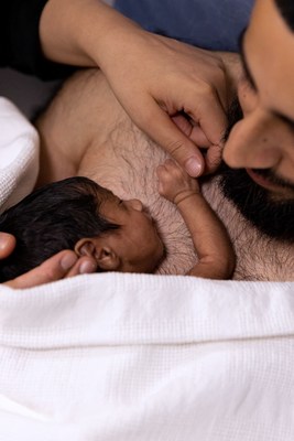 Parent skin to skin cuddling their premature baby at Birmingham Women's Hospital