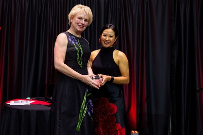 Patty Leyendecker, Chief Development Officer, YWPN receiving award from HTHH board member Alexa Nguyen