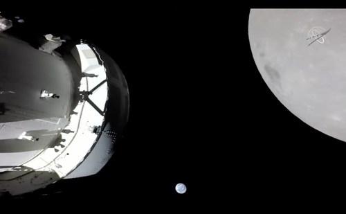 On Nov. 21, 2022, a camera on Orion's solar array wing captured this view of the spacecraft, the Earth and the Moon. Orion was making its outbound powered flyby of the Moon as part of the Artemis I mission, approaching within 80 miles of the lunar surface. Artemis I, the first flight test of NASA's Orion capsule and Space Launch System rocket, launched Nov. 16, 2022, and is scheduled to splashdown Dec. 11. Credit: NASA TV