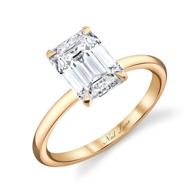 A stunning 18k rose gold diamond ring, centrally set with an emerald cut diamond further accented by 16 small round white diamonds and 8 fancy pink diamonds.