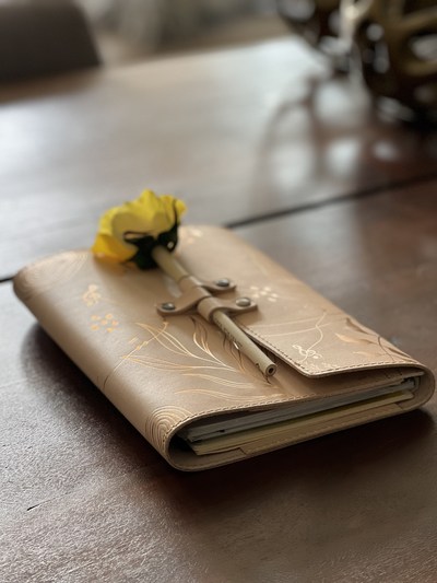 Natural color Symphony of Life Agenda Planning Cover in hand hewn leather with copper detail come in four colors: black, natural, newbuck and saddle. Made in the USA.