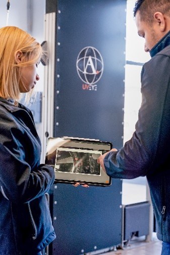 An office manager at Volvo Cars Princeton, reviews the results of an Artemis tire inspection with a service adviser