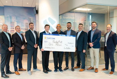 SouthState Regional President Angel Gonzalez presents a $1 million donation on behalf of SouthState to Family First, a Tampa-based national non-profit founded by Mark Merrill. He is joined by All Pro Dad national spokesman, former Super Bowl-winning Head Coach and Pro Football Hall of Famer, Tony Dungy.