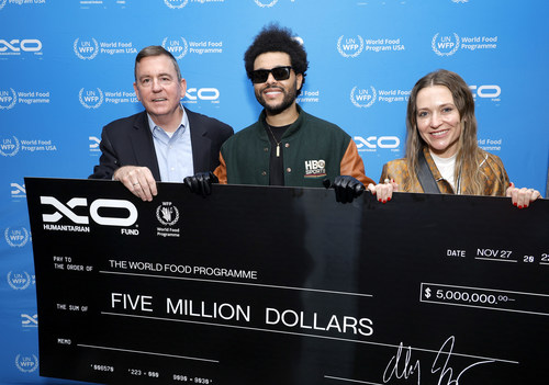 The Weeknd presents $5 million to World Food Program USA President and CEO Barron Segar, along with Sarah Dale, Binance. Photo credit: Frazer Harrison/Getty Images The Weeknd presents $5 million to World Food Program USA President and CEO Barron Segar, along with Sarah Dale, Binance. Photo credit: Frazer Harrison/Getty Images