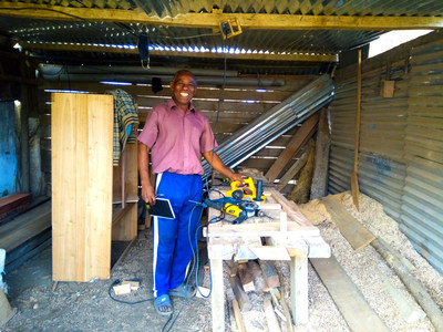 Worker using electricity from a mini-grid supported by the Universal Energy Facility in Madagascar.