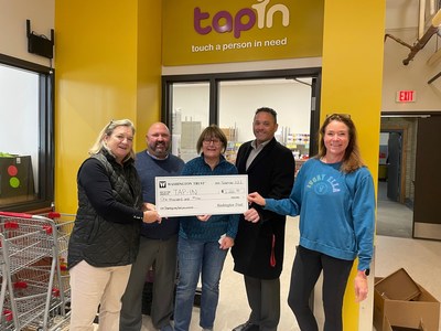 The Washington Trust Charitable Foundation donated $1,000 to TAP-IN, a hunger relief organization based in Barrington, RI that serves residents of the East Bay, to support their holiday food procurement & distribution efforts. From L to R: Laurie Ward, TAP-IN volunteer; Matthew Raiche, VP, Regional Manager at Washington Trust; Marie Carreiro, TAP-IN volunteer; Michael Geoghegan, Jr., AVP, Branch Manager of the future Washington Trust branch in Barrington; and Shauna Hyde, TAP-IN volunteer.