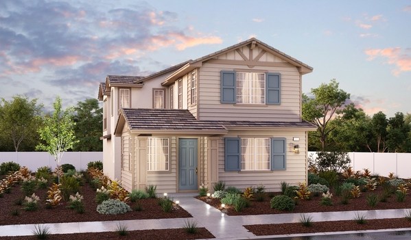 Two-story home at dusk with sidewalk leading up to front door