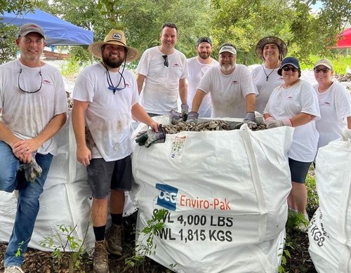 Volunteers from Ports America working to transfer bagged oyster shells from pallets to OEG super sacks.