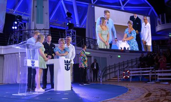 December 2022 – In a celebration fit for the world’s newest wonder, Royal Caribbean International officially welcomed Wonder of the Seas into the family in its new year-round home of Port Canaveral, Florida. Godmother and Wonder Mom from Pennsylvania Marie McCrea bestowed a blessing of safekeeping on the new ship, its crew and all who sail on it. In the one-of-a-kind AquaTheater, she was joined by Royal Caribbean Group President and CEO Jason Liberty, Royal Caribbean International President and CEO Michael Bayley, and her daughter, Allie, who nominated her for the role as part of the TikTok search launched by the cruise line. (PRNewsfoto/Royal Caribbean International)