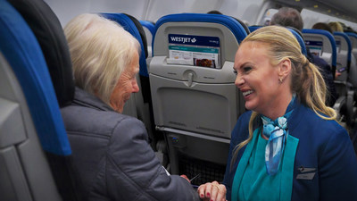 WestJet guests surprised in-flight with opportunity to give back $1 for every mile flown to their favourite charities or non-profit organizations (CNW Group/WESTJET, an Alberta Partnership)
