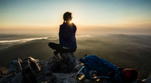 A hiker overlooks the Arkansas River Valley from high atop Pinnacle Mountain State Park in Arkansas following an early morning hike. Courtesy: Arkansas State Parks