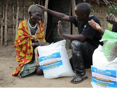 Helping Hand USA volunteer distributing food packages to families in Uganda, 2022