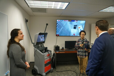 VRSim, Inc. staff (left to right) Sara Blackstock and Alejo Fudge, demonstrating SimSpray, a virtual reality training system for painting and coatings, for U.S. Senator Chris Murphy (D-Conn.) during a visit to VRSim, Inc. in East Hartford, CT on Wednesday, January 4, 2023. Photo credit: Jameson Foulke.