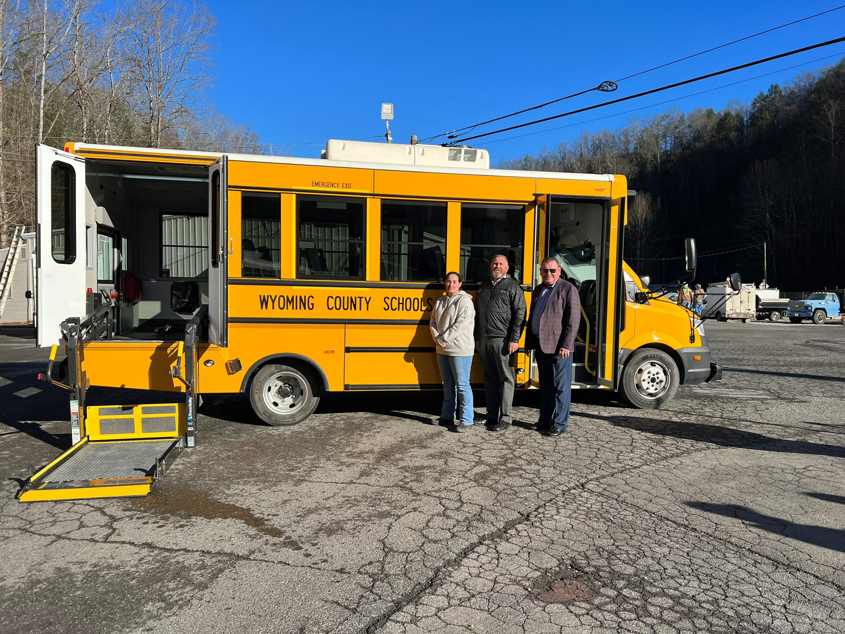 Wyoming County Schools bus driver Heather Rocchi and Jeff Hylton, Director of Safety and Transportation, take delivery of GreenPower’s all-electric Type A Nano BEAST school bus from and GreenPower Vice President Mark Nestlen.