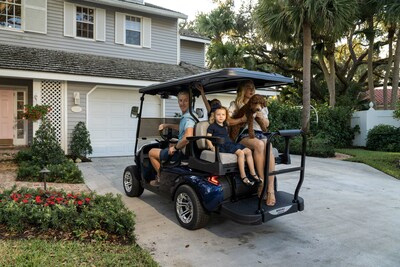 Young family riding in MadJax XSeries Storm golf cart