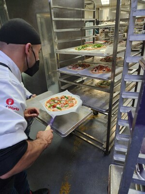 A culinary student with the C-CAP/Fortune Society culinary program in New York City gets ready to bake up some pizzas.