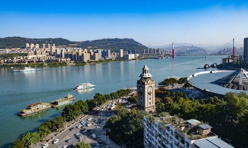 The ancient Xishan bell tower, facing green waters and mountains, stands witness to Wanzhou's new development.