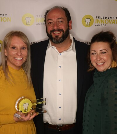 Heather Luebben, ADT, and Natalie Olsen, DA, accept the 2022 Tellie Award from MouthWatch founder and CEO, Brant Herman, for their incorporation of teledentistry in their eight Centers for Dental Health and service to children with special needs.