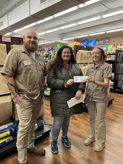 Petland staffers at the Petland store in Richmond, Indiana present a donation to HELP the animals.