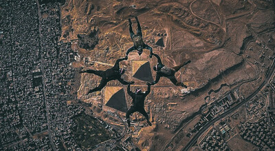 Mike Sarraille, Andy Stumpf, Fred Williams, and Glenn Cowan skydive into the pyramids in Cairo Egypt in their fifth jump of the Triple7 expedition