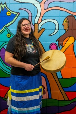 Lucia Laford, an artist with VIBE Arts, in front of Exploring Woodland, a mural painted by Lucia and students at École Notre Dame Du Sault, supported by Ontario Trillium Foundation, photo courtesy of Krystiana Bourdage. (CNW Group/Bell Canada)