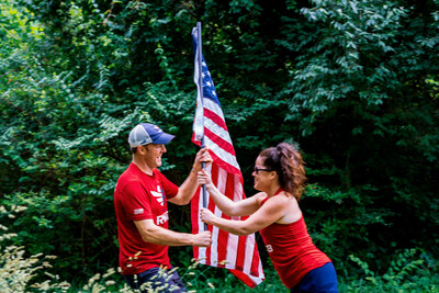 Team Red, White & Blue members pass the Old Glory Relay flag from one runner to the other.