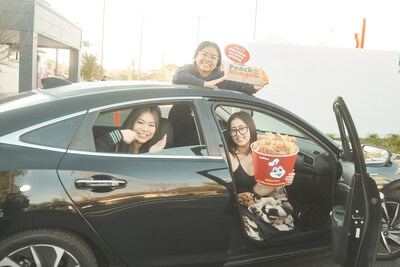 Jasmine Hong (left) poses with her friends from the University of Central Florida in the car they camped out in for more than 13 hours to try Jollibee for the very first time. Jolly day, indeed! (Photo credit: Jollibee).