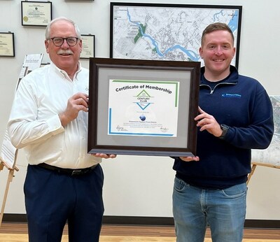 DIPRA Regional Director Paul Hanson, P.E. (left), is shown presenting the Century Club Recognition to T.C. Schofield, P.E., District Engineer, Brunswick & Topsham Water District (right).