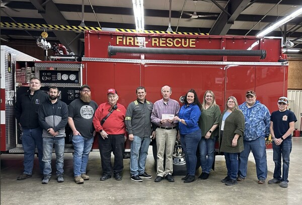 Felman Production representatives present a donation on behalf of the company to the New Haven and Community Volunteer Fire Department.