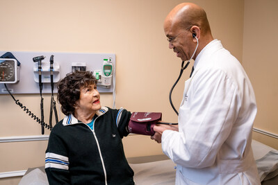 Reggie Ross, M.D., ChenMed Regional Chief Clinical Officer, right, sees patient benefiting from a same-day appointment.