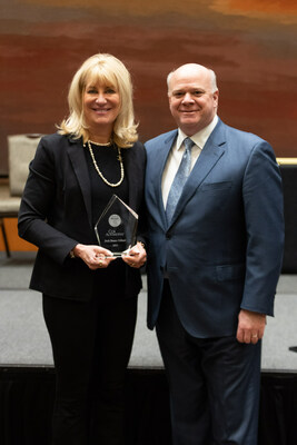 Beth Beans Gilbert (left), Vice President of Fred Beans Automotive Group, receives 2023 Barbara Cox Woman of the Year Award from Cox Automotive President Steve Rowley (right).