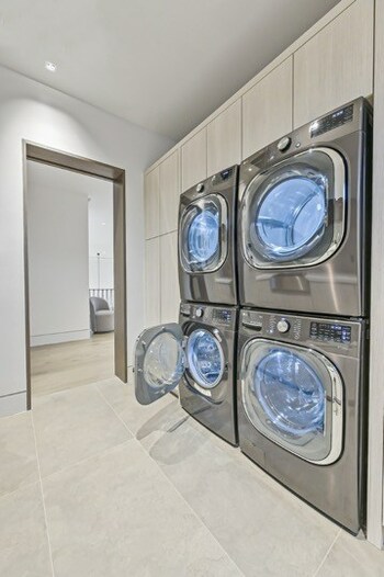 Located in the laundry room on the second level of the home are dual laundry systems including the ENERGY STAR® certified TurboWash front-load washer.  Image Credit: Joel Gamble/ Klassick vision studios