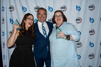 Erin Zaborac (Ansira), Brian Pasch, and Colleen Harris (Ansira) pose with the Ansira's 2023 AWA Awards in the Digital Marketing category and the Website Platform category.