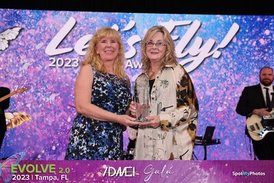 Ultimate Ventures President, Laurie Sprouse, presenting the Lifetime Achievement Award to Beverly Brin at the ADMEI Awards Banquet.