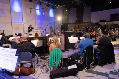 Dan Redfeld (Composer) at EastWest Studios in Hollywood, CA conducting a 29 piece orchestra at the Demo Recording Session for Little Women in October of 2022.