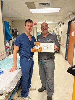 Michael J. Greller, MD, MBA, CPE, FAAOS, and Garret L. Sobol, MD, holding the BEAR Implant and the BEAR Implant mascot