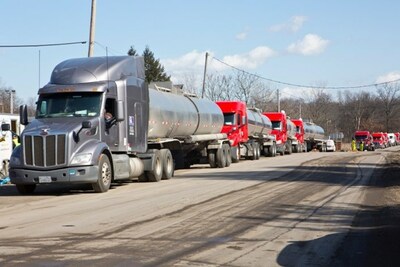 A line of tanker trucks on standby for managing water on site.