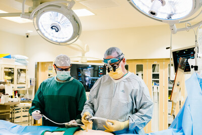 Surgical Tech Patrick O’Connor (left) assists Cardiothoracic Surgeon Michael Bradner, MD, prepare for surgery at St. Joseph’s Hospital, a 2023 PINC AI 50 Top Cardiovascular Hospital.